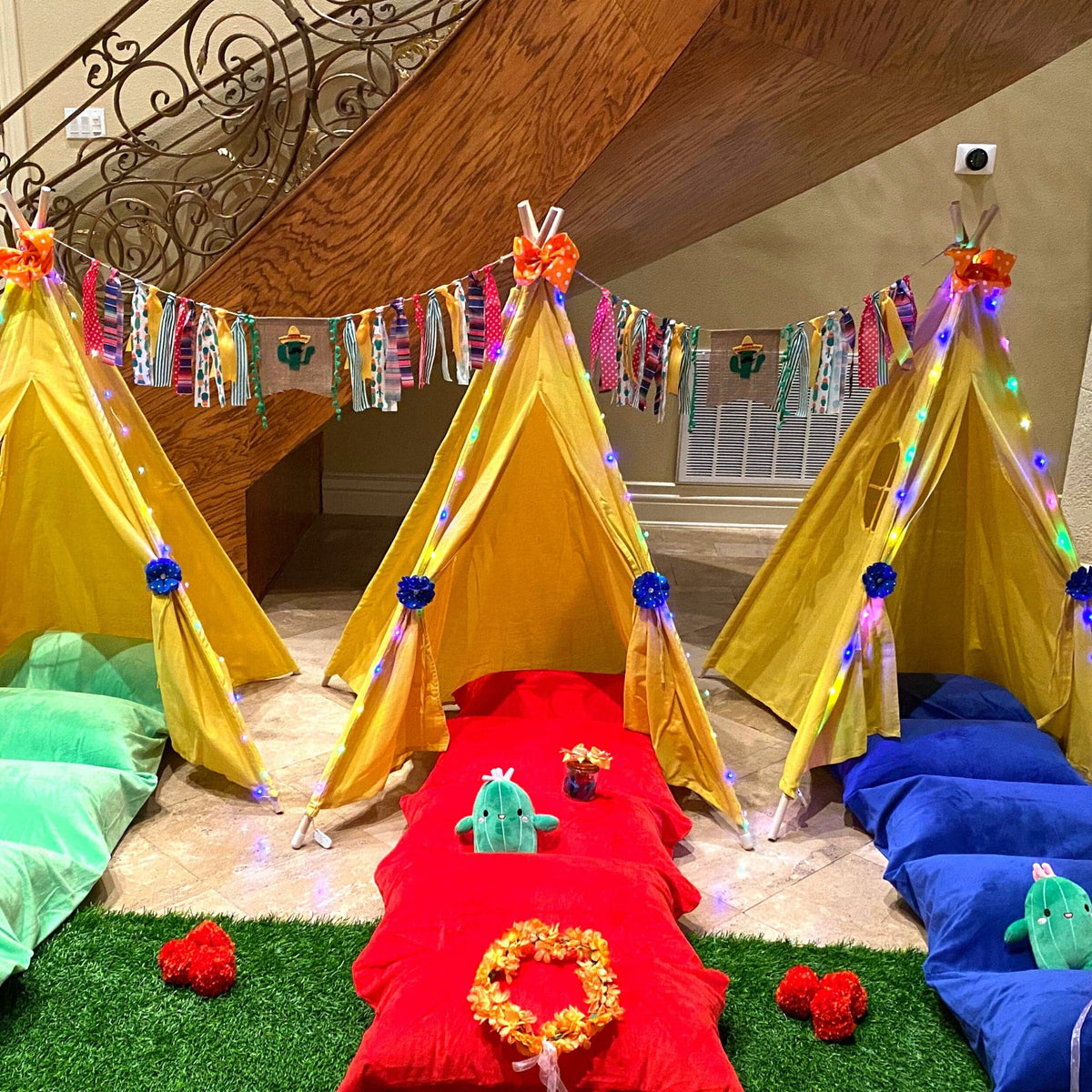 Fiesta Banner garland with colorful ribbons and cactus accents over yellow teepees on Tampa Home & Garden Store