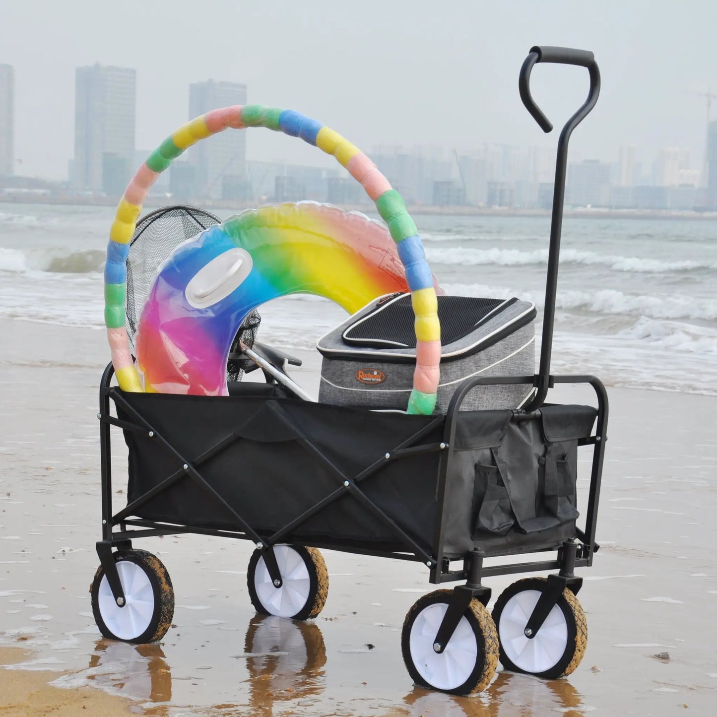 Folding Wagon Garden Cart Beach Black with black frame and white wheels on sandy beach on Tampa Home & Garden Store