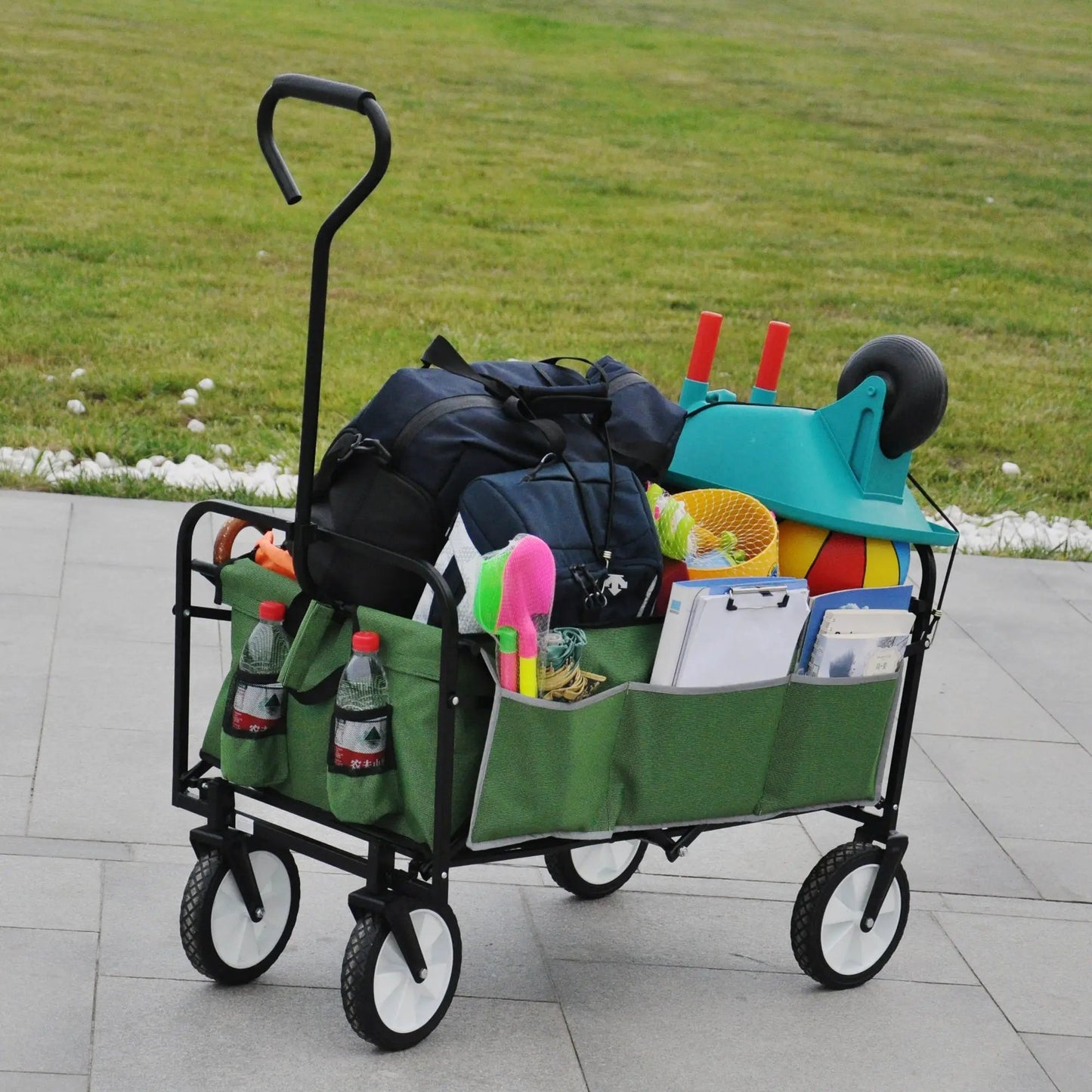 Folding wagon cart grass-green with black frame loaded with bags and outdoor gear on Tampa Home & Garden Store