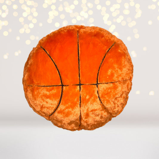 Basketball-style plush throw pillow in bright orange with black seam lines on Tampa Home & Garden Store