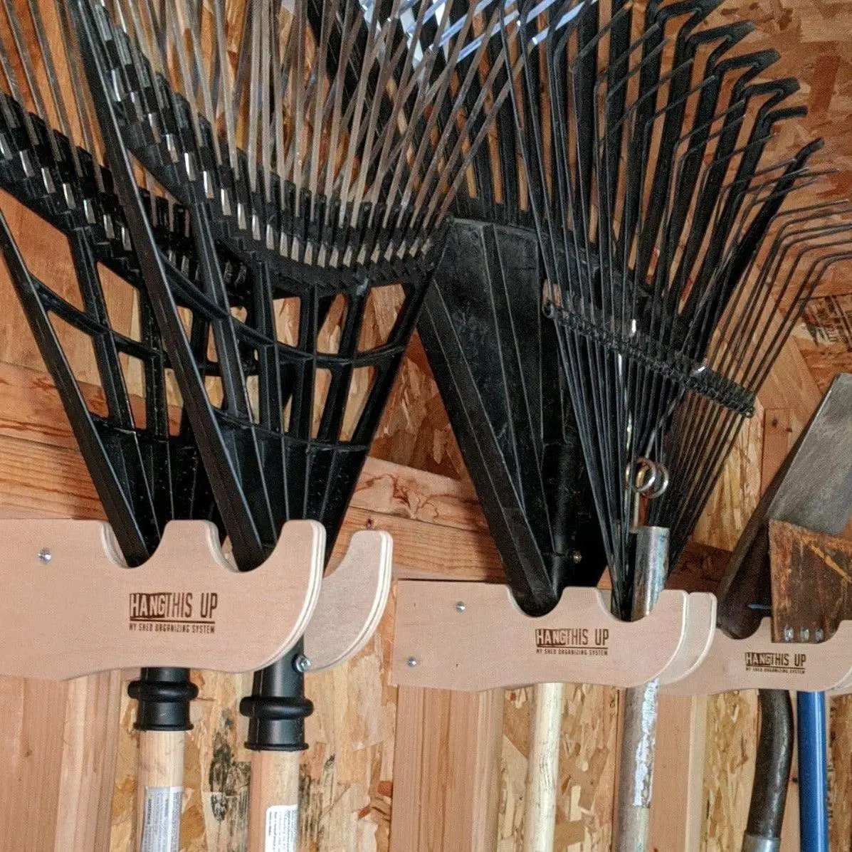 Garden Tool Organizer for Shed tool rack with beige HangThis Up system and black rake heads on Tampa Home & Garden Store