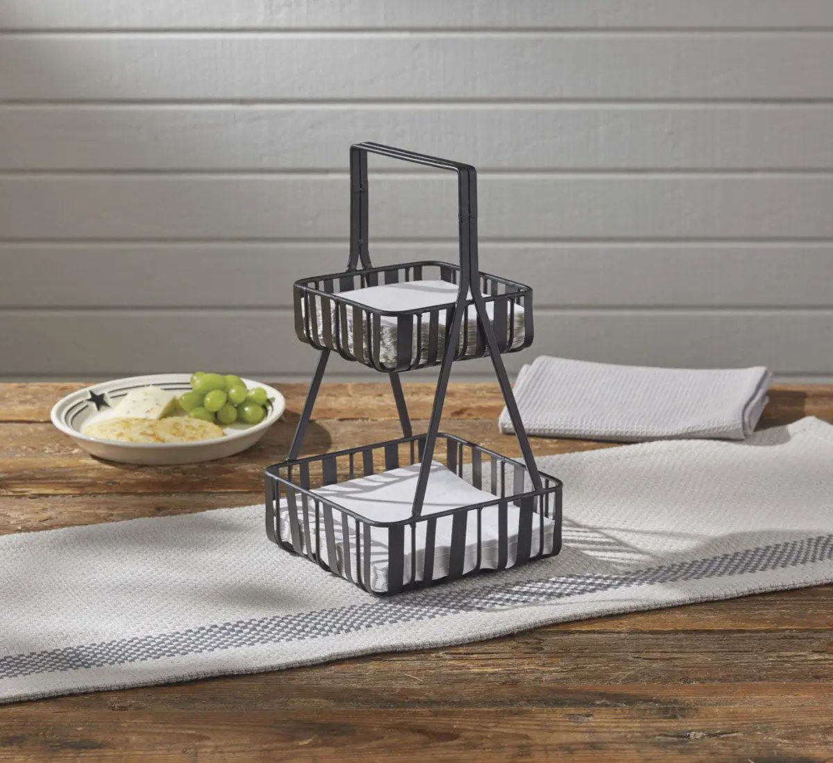 Spencer two-tier napkin holder, black metal, two baskets with white napkins on Tampa Home & Garden Store
