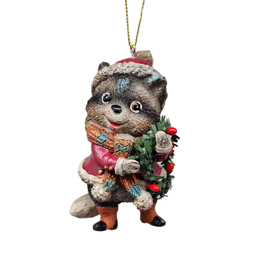 Whimsical raccoon ornament in red coat with scarf and festive greenery on Tampa Home & Garden Store