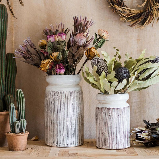 Glazed ceramic vases, white with brown vertical stripes, two sizes with dried flowers on Tampa Home & Garden Store