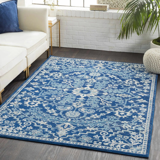 Boutique Rugs Blue Bodrum area rug with teal and navy medallion pattern under a white sofa on Tampa Home & Garden Store