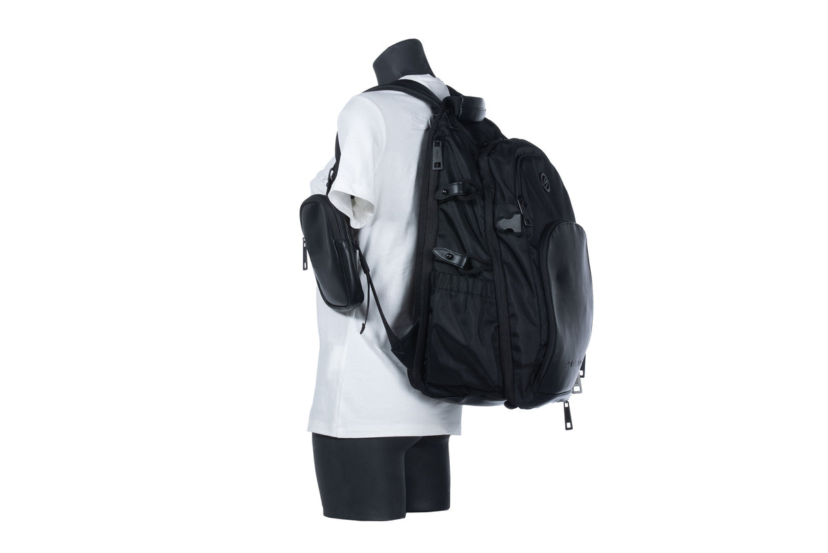 Suomy Groom Backpack black with multiple zip compartments and mesh pockets on a mannequin wearing a white shirt on Tampa Home & Garden Store