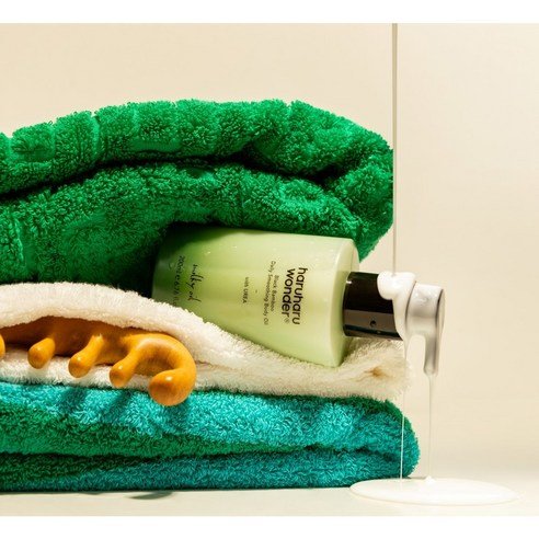 Body oil haruharu wonder Black Bamboo Daily Smoothing bottle with pump on green towels by Seoulia on Tampa Home & Garden Store