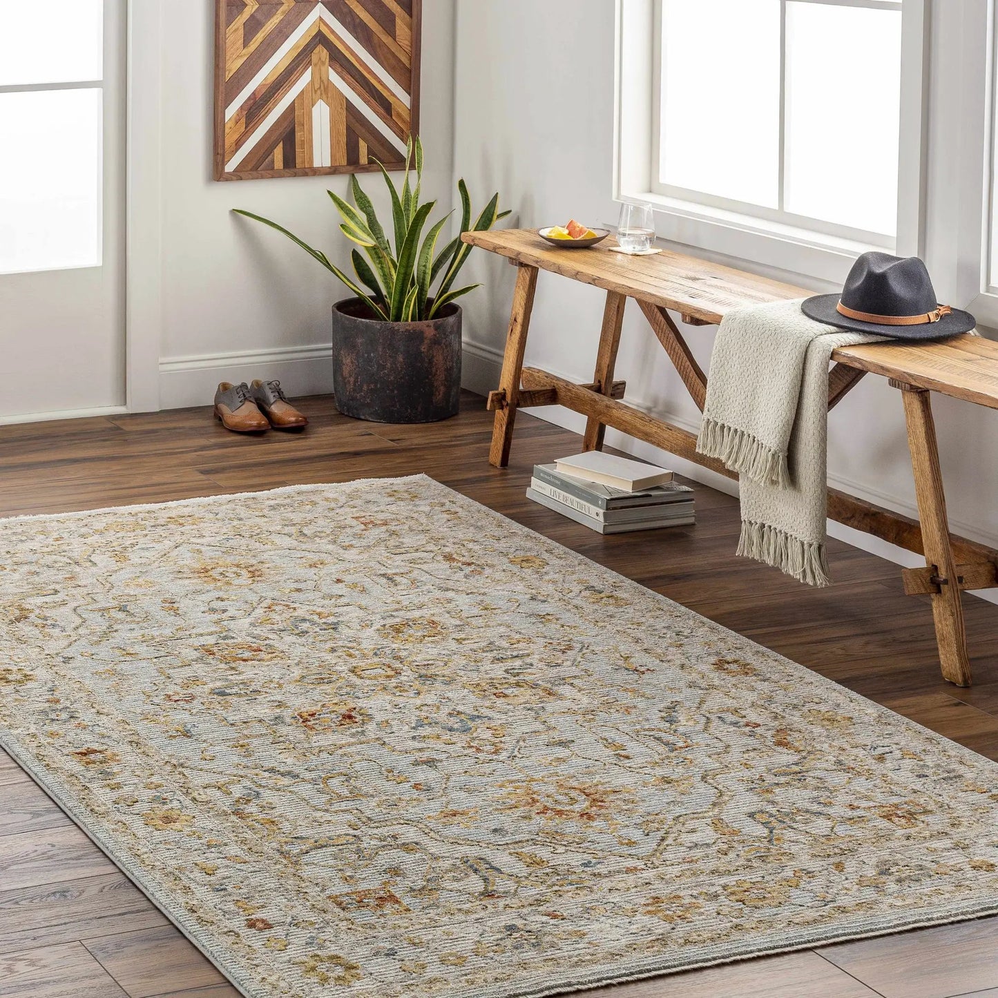 Huguley Floral Cream Luxe Rug Oriental Pattern in a room with a rustic bench and potted plant on Tampa Home & Garden Store
