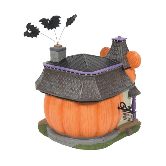Mickey's Haunted Manor Lights Up Village Display atop a pumpkin house with purple trim on Tampa Home & Garden Store