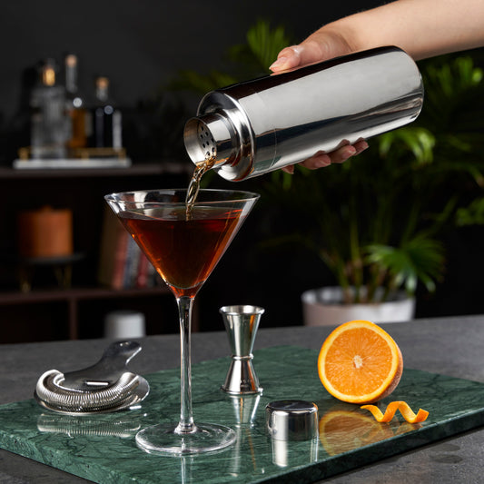 Harrison Element cocktail shaker by Viski pouring amber cocktail into a martini glass on Tampa Home & Garden Store