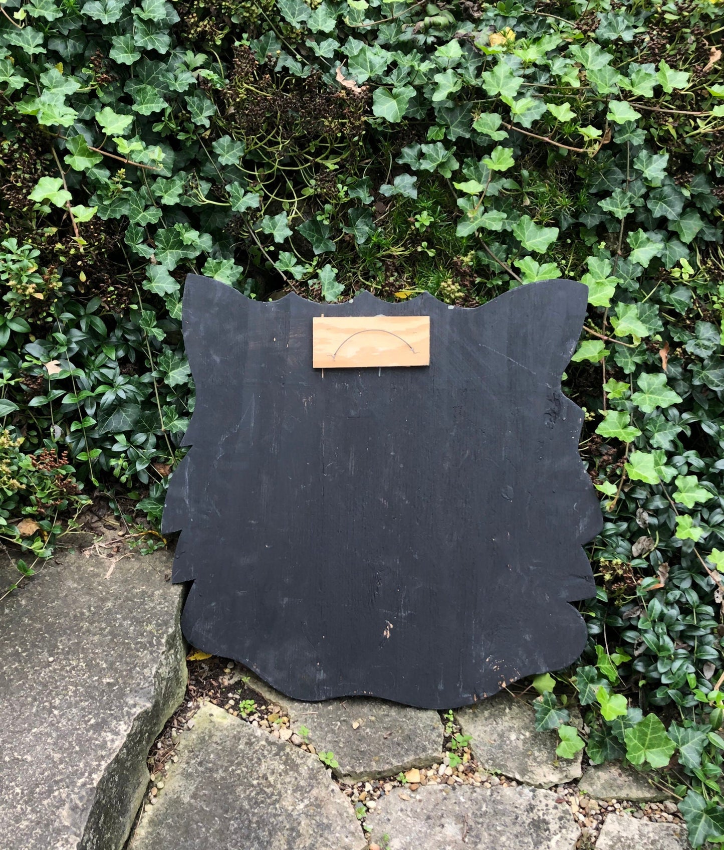 Sign on Wooden Black Cat Cutout Reading Happy Halloween.