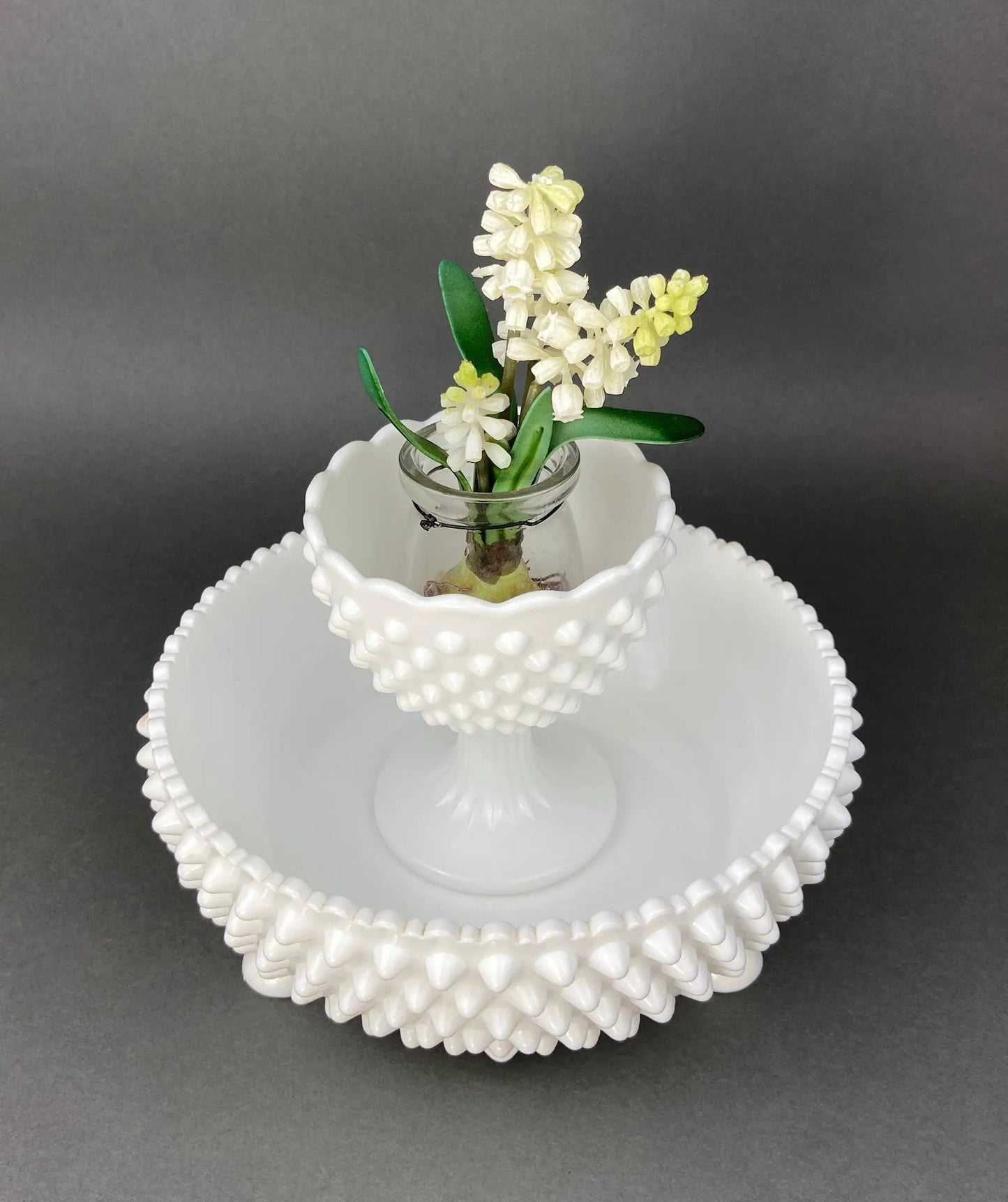 Milk glass footed candy dish with beaded scalloped edge, paired with a vase of white flowers on Tampa Home & Garden Store