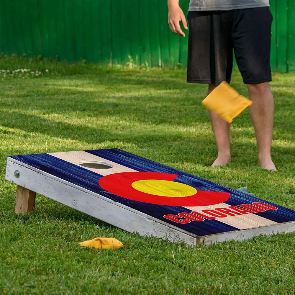 Cornhole board wrap set of 2 in blue with tan stripe and red Colorado emblem on grass on Tampa Home & Garden Store