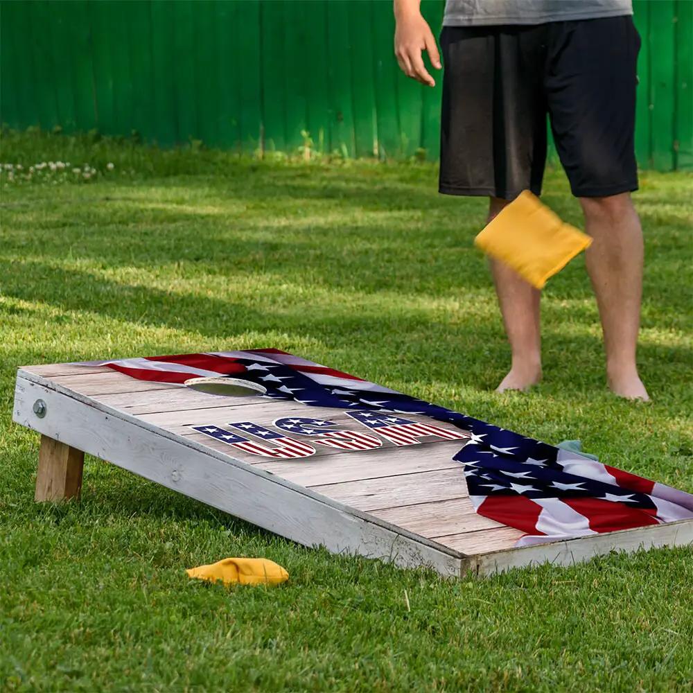 USA Flag Cornhole Board Wraps set of 2 on a weathered wooden cornhole board outdoors on Tampa Home & Garden Store