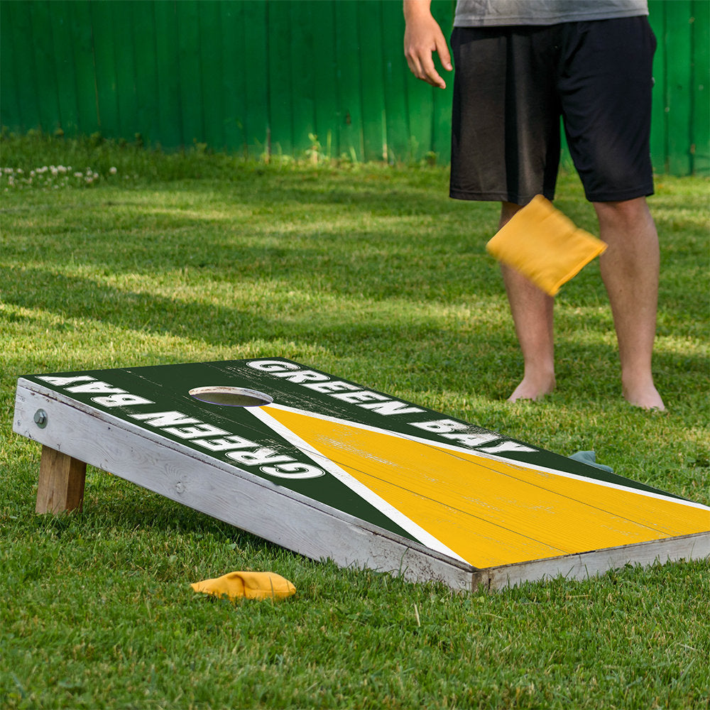 Green Bay football cornhole board wrap set of 2 in dark green with yellow stripe on grass on Tampa Home & Garden Store