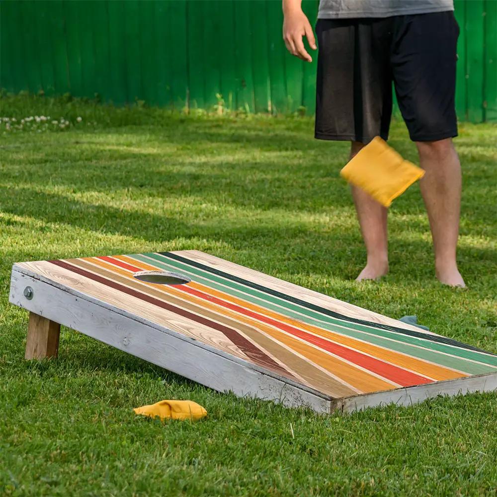 Carnival Slide Cornhole board wrap set by Lone Star Art, colorful striped, set of 2 outdoors on Tampa Home & Garden Store