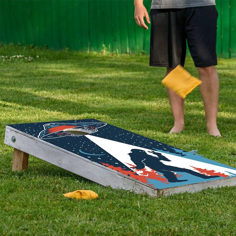 Cornhole wrap set of 2 featuring UFO and Big Foot on dark blue backdrop by Lone Star Art on Tampa Home & Garden Store