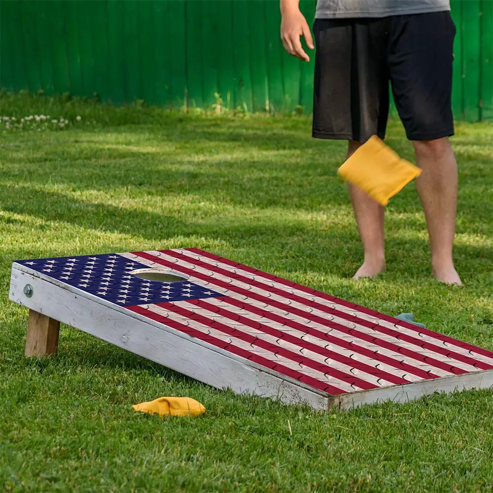 Cornhole wrap set of 2 USA flag design on boards yard with yellow bag on Tampa Home & Garden Store