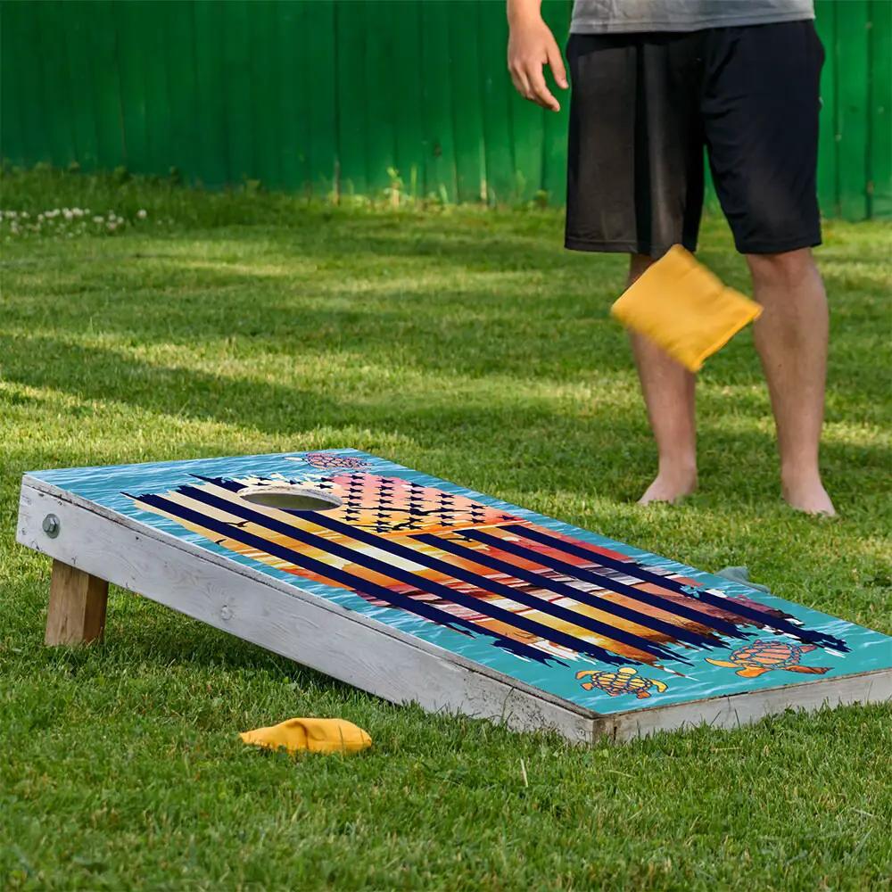 Sunset Sea Turtle and American Flag Cornhole Wrap by Lone Star Art on turquoise striped board on Tampa Home & Garden Store