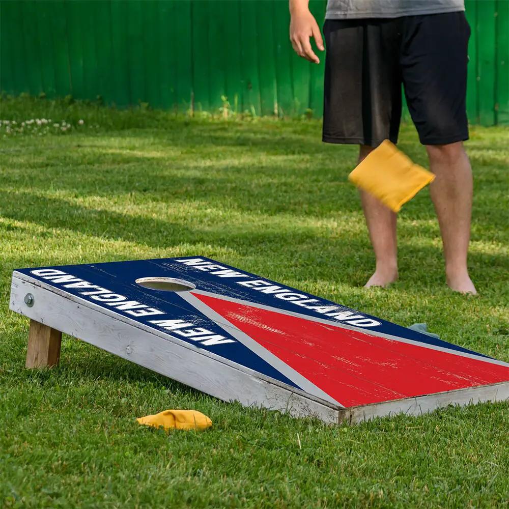Cornhole board wraps set of 2 with New England Football design in blue and red stripe on grass on Tampa Home & Garden Store