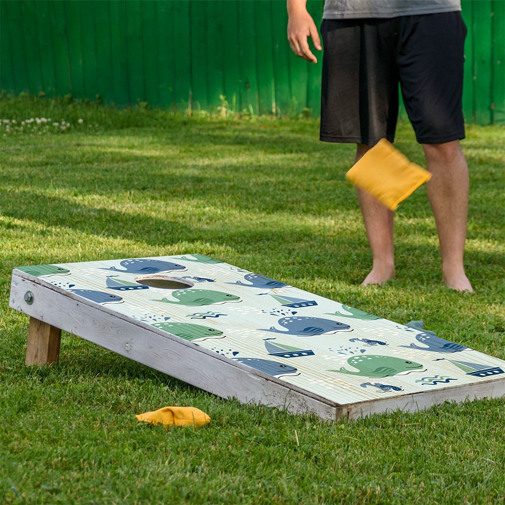 Cornhole board wrap Sea Turtles and Whales in blue green hues; wooden board on Tampa Home & Garden Store
