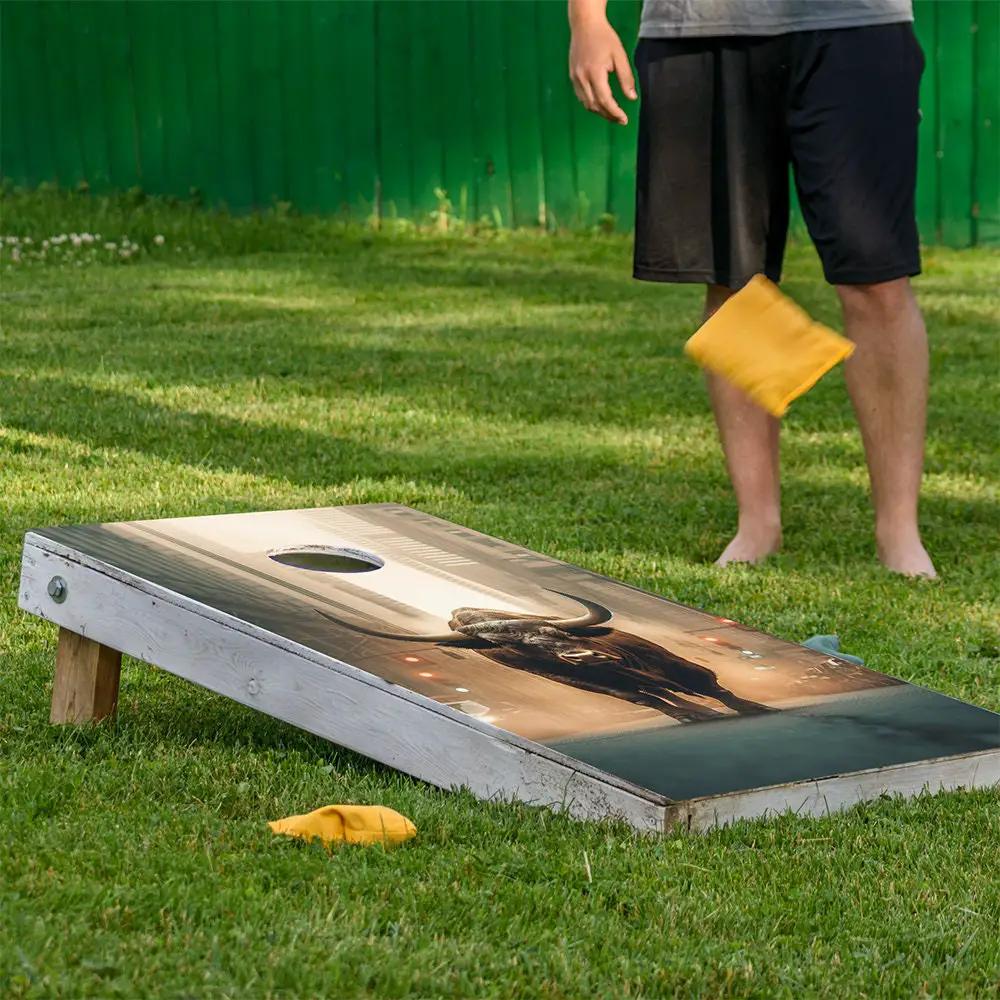 Cornhole board wrap featuring Wall Street Bear and Bull with yellow bean bags by Lone Star Art on Tampa Home & Garden Store