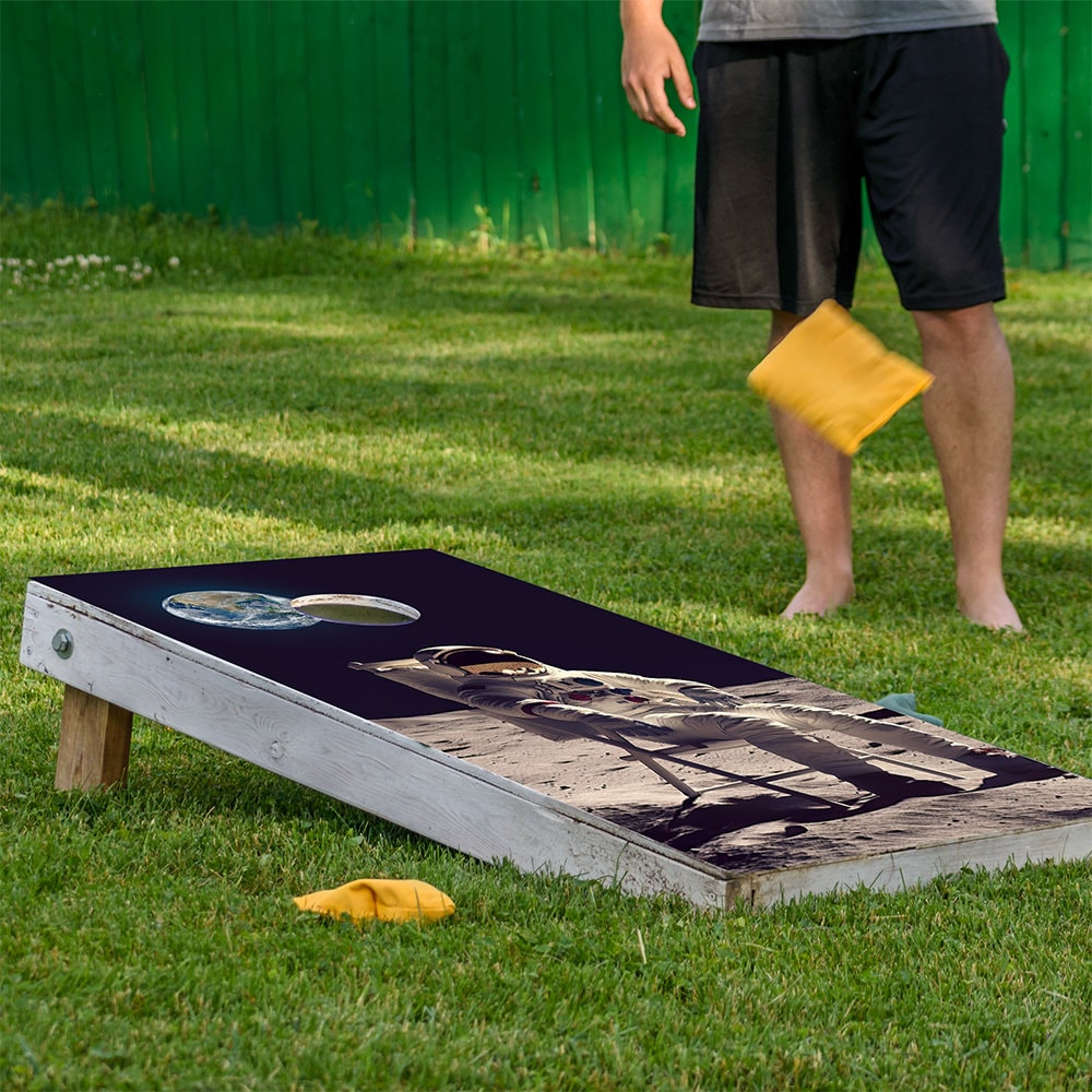 Lunar Lounger cornhole board wraps 2-pack with astronaut art on navy surface Lone Star Art on Tampa Home & Garden Store