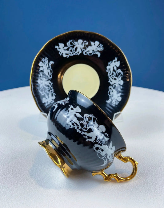 Vintage bone china cup and saucer set black with white cherub motifs and gold trim on Tampa Home & Garden Store