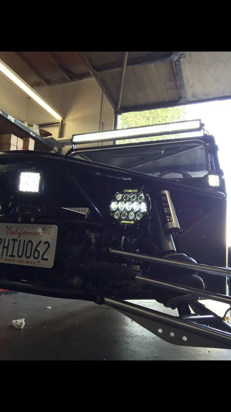 Round Plug and Play Jeep headlight replacement pod by GGLighting on a black off-road Jeep on Tampa Home & Garden Store
