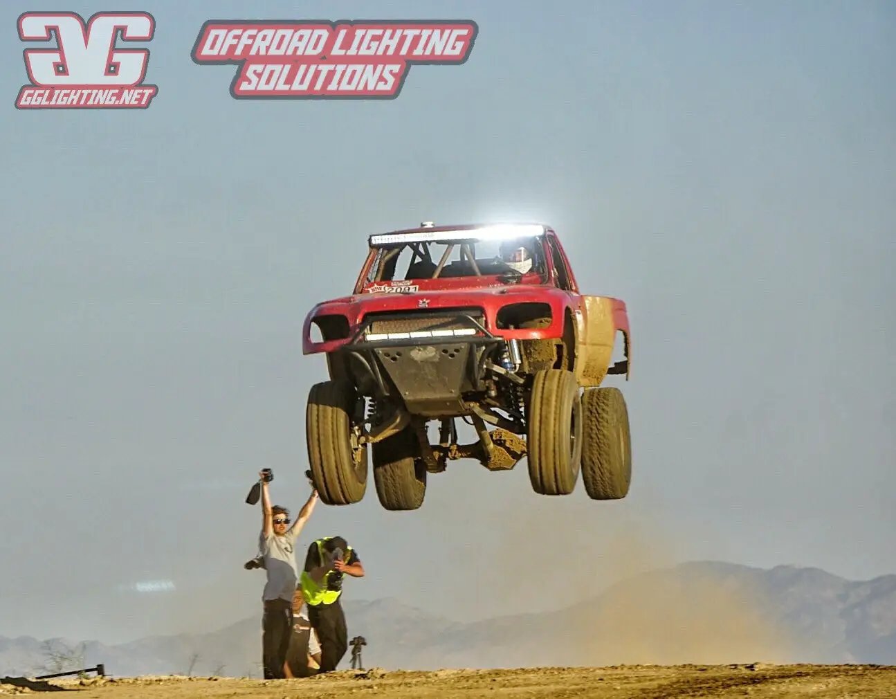 Race Series 30 Inch LED Light Bar on a red off-road truck mid-jump, GGLighting on Tampa Home & Garden Store