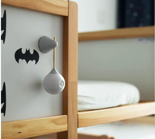 Motion Sensor Night Light gray plastic pendant hanging from a wooden dresser in a bedroom on Tampa Home & Garden Store