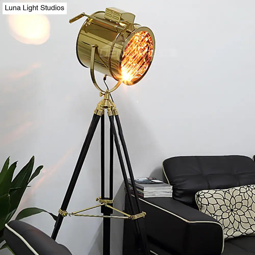 Tripod metal floor lamp with brass-gold spotlight head and black legs by Decorbites on Tampa Home & Garden Store