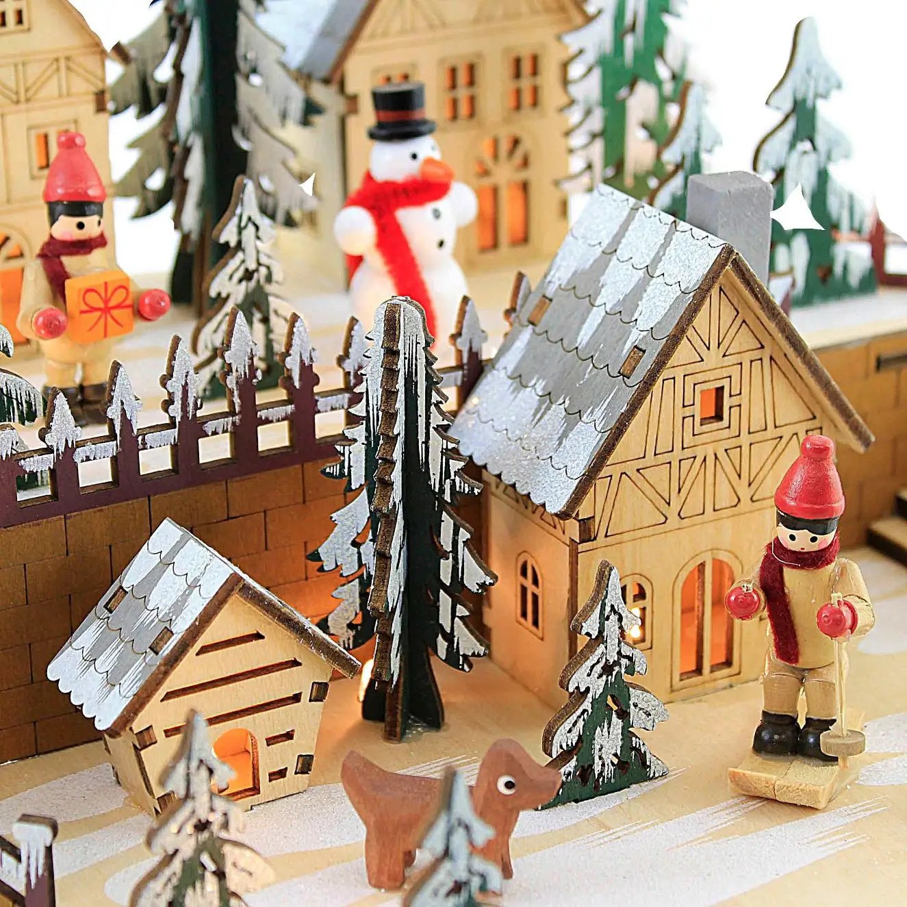 LED Star Shape Wooden Village Scene with snow-dusted roofs, trees and festive figures on Tampa Home & Garden Store
