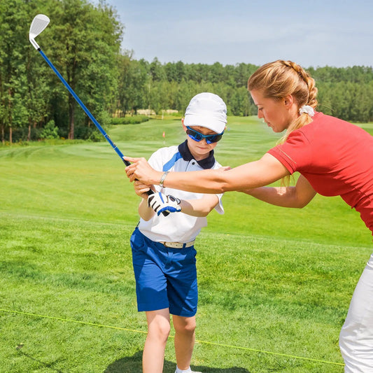 Junior 7 iron for kids with fiberglass blue shaft and white head being guided on a sunny course on Tampa Home & Garden Store