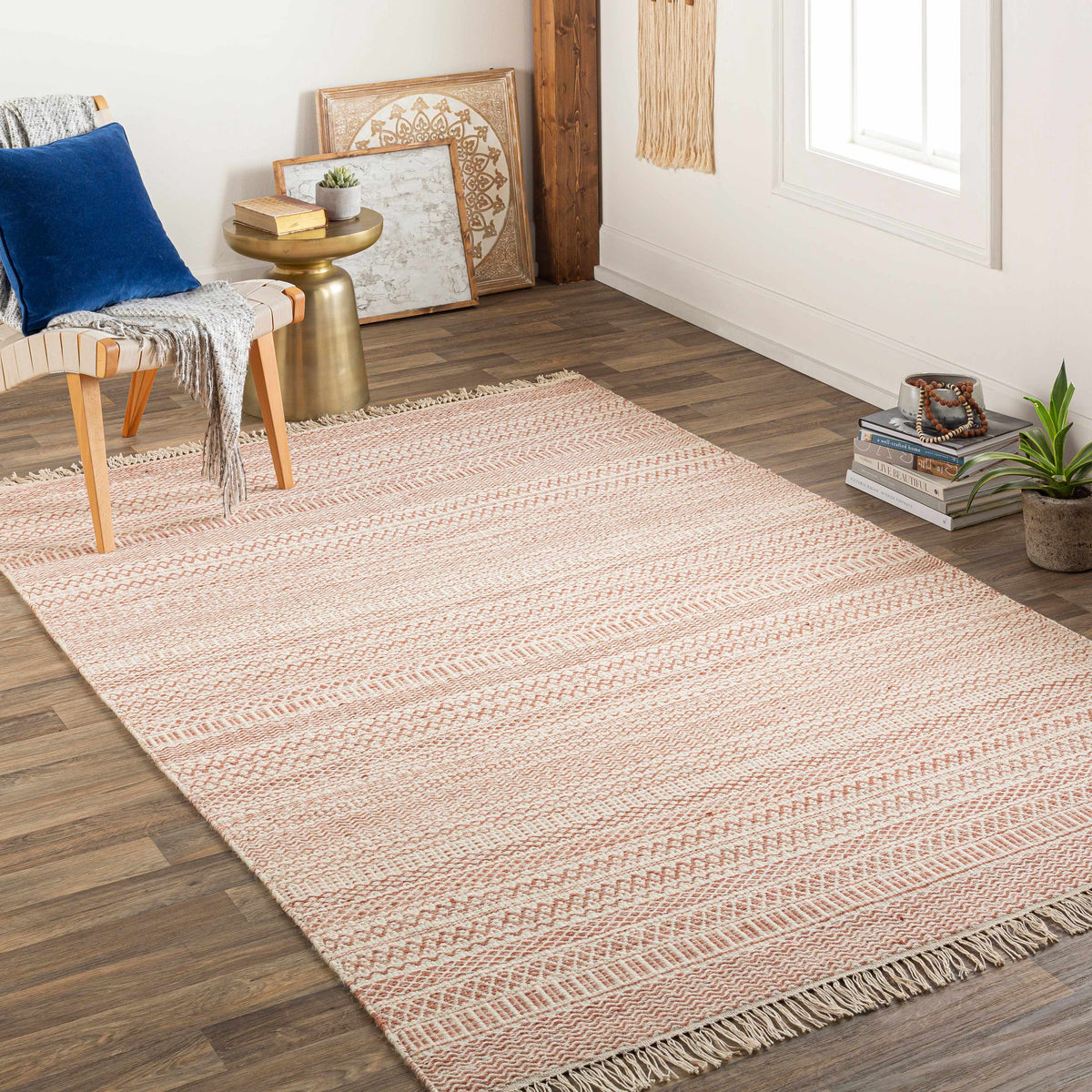 Kalinga red/cream flatweave wool rug by Boutique Rugs with fringed edges in a cozy living room on Tampa Home & Garden Store