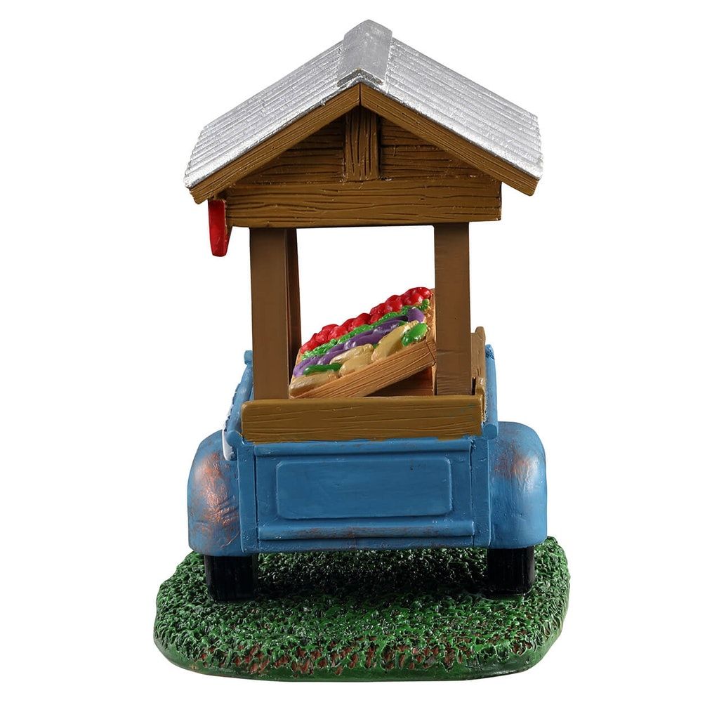 Farm Fresh Vegetable Trailer on blue truck with rustic tin roof and crate of produce on Tampa Home & Garden Store