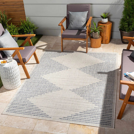 Khandallah Outdoor Area Rug Turkish polypropylene, light with blue stripes on patio with chairs on Tampa Home & Garden Store
