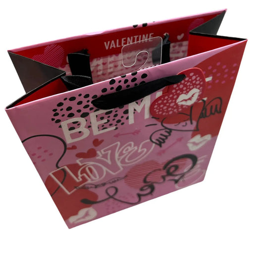 Be Mine Valentine gift bag with pink background, hearts, and black ribbon handles on Tampa Home & Garden Store