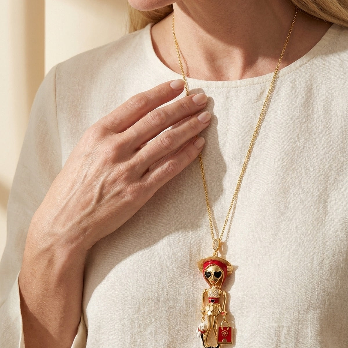 Uptown Girls Pendant Necklace gold-tone chain with whimsical girl charm and red accents on Tampa Home & Garden Store