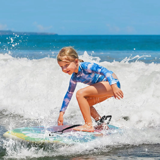 Lightweight bodyboard with EPS core and HDPE deck, multicolor pattern, kid riding a wave on Tampa Home & Garden Store