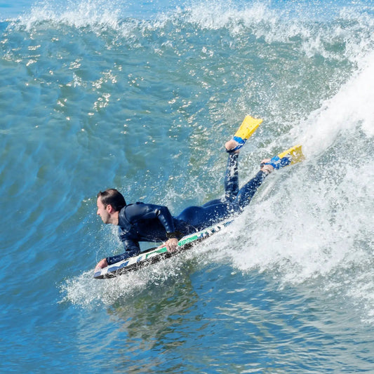 Lightweight body board with multicolor deck ridden on a blue wave by a surfer DirectDeals on Tampa Home & Garden Store