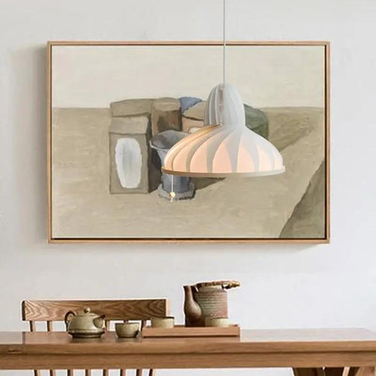 Origami pendant lamp with white folded shade over wooden table on Tampa Home & Garden Store
