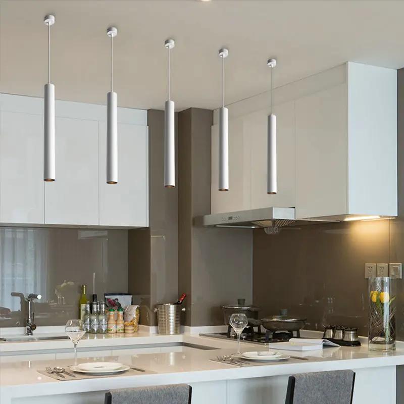 Modern LED iron pendant lamps with five slim silver cylinders over a white kitchen island on Tampa Home & Garden Store