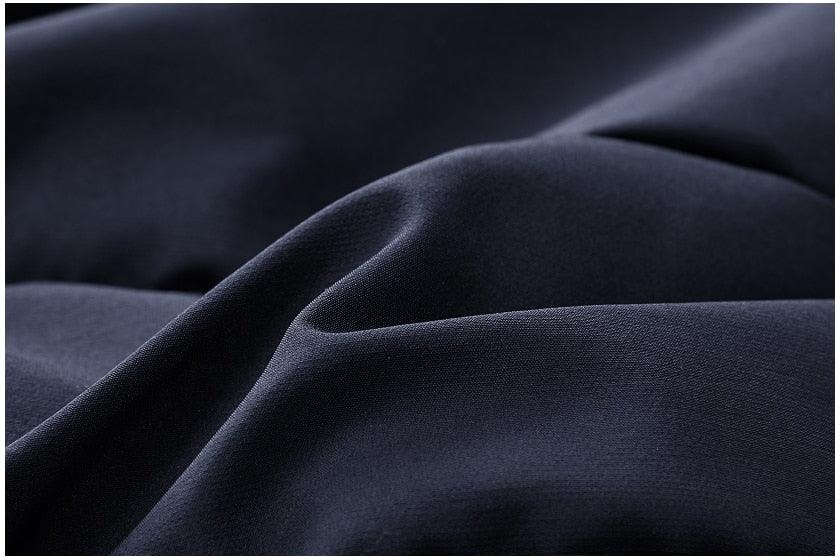 Stevvex navy parka fabric close-up showing thick windproof coat material on Tampa Home & Garden Store