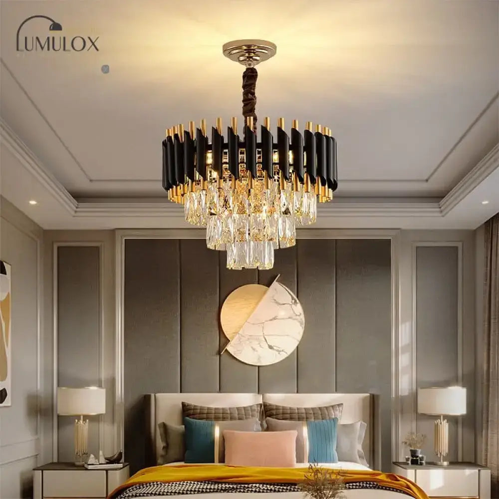 Black crystal tiered chandelier with gold accents hangs from the ceiling above a bedroom on Tampa Home & Garden Store