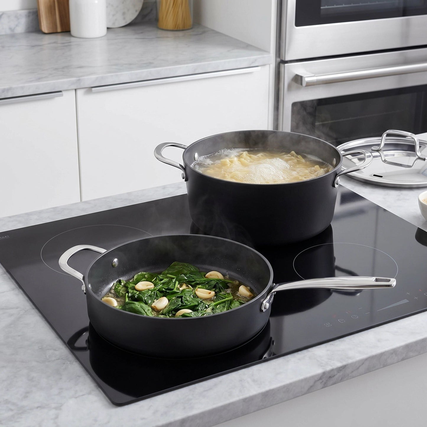 Ceramic nonstick cookware set by Alva Cookware; two black pots with lids on an induction cooktop on Tampa Home & Garden Store