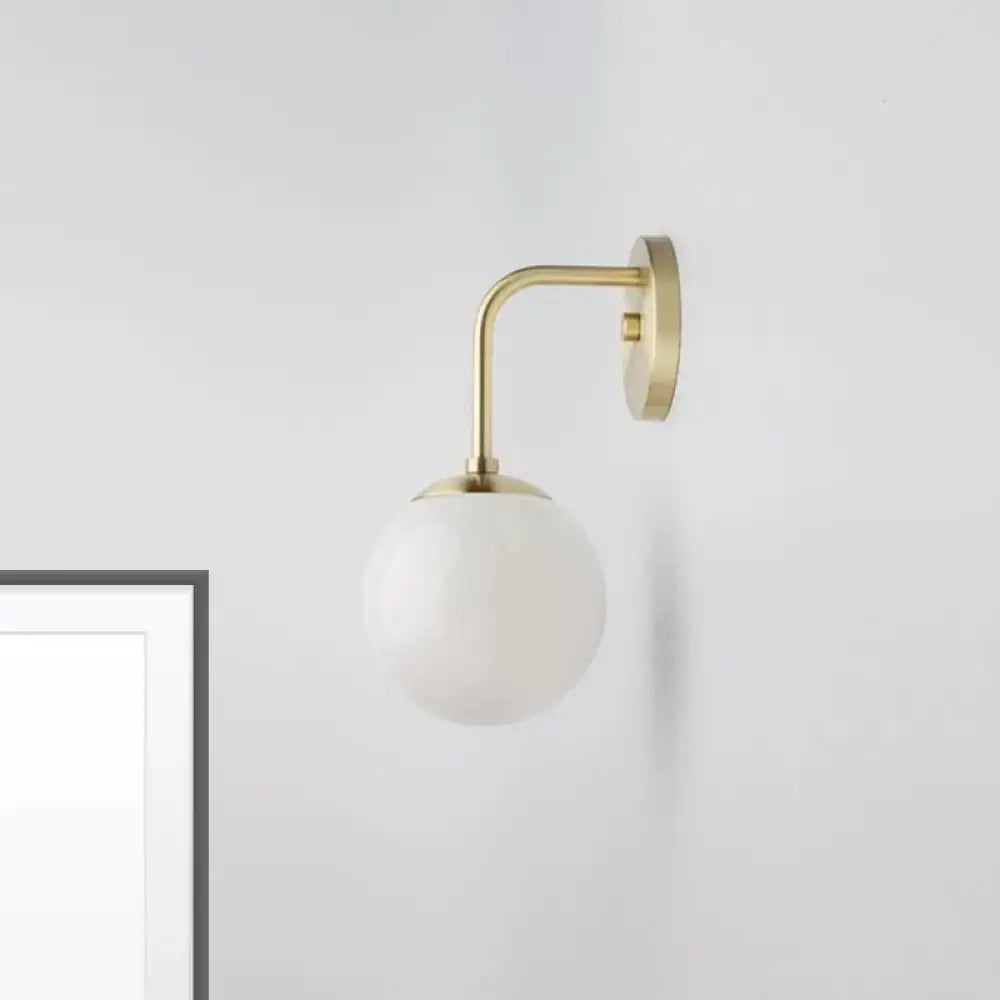 Milky Glass Ball Wall Lamp by Decorbites; brass curved arm, white glass globe, wall-mounted on Tampa Home & Garden Store