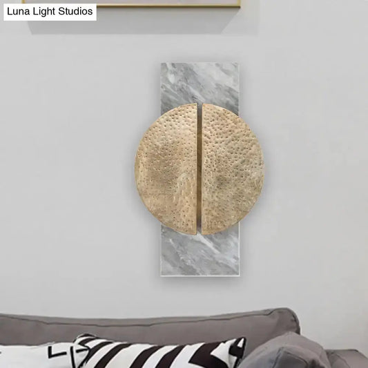 Minimalist black marble wall lamp with hammered gold circle sconce on marble backplate on Tampa Home & Garden Store