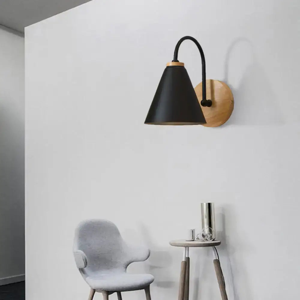 Black conical gooseneck wall sconce with wood backplate on white wall on Tampa Home & Garden Store