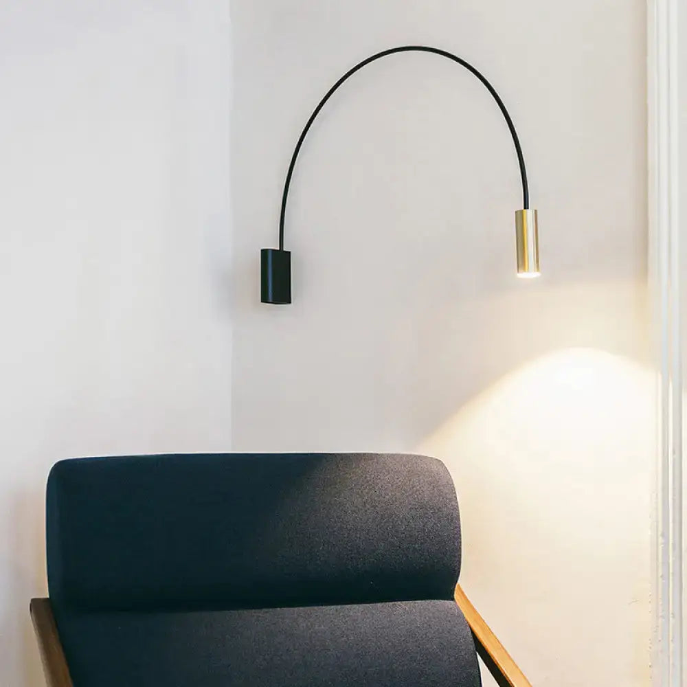 Black arched LED wall light with black base and gold cylindrical lamp by Decorbites on Tampa Home & Garden Store